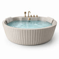 Baignoire ronde en pierre composite beige avec robinets en laiton